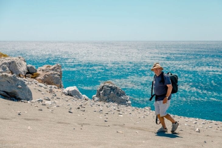 Senior Mann beim Strandspaziergang auf Kreta