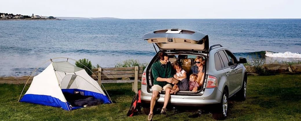 Family sitting in the back of an SUV